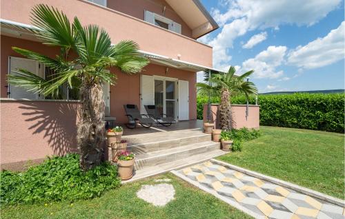 a house with a staircase and palm trees at Holiday Home Trilj 85 With Outdoor Swimmingpool in Trilj