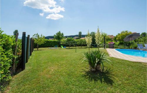 a garden with a swimming pool and a playground at Holiday Home Trilj 85 With Outdoor Swimmingpool in Trilj