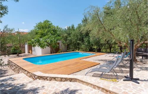 a pool with a wooden deck and a slide at 5 Bedroom Lovely Home In Posedarje in Posedarje