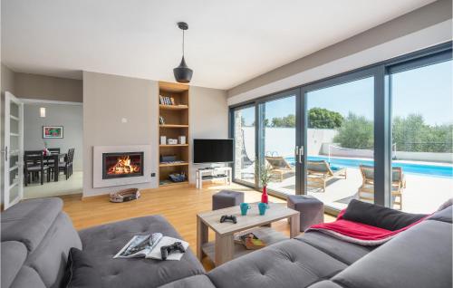 a living room with a couch and a fireplace at Nice Home In Valtura With Sauna in Valtura