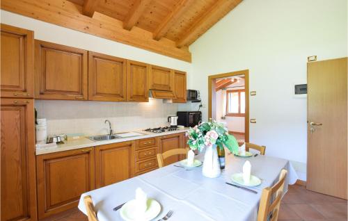 a kitchen with a table with a white table cloth at Beautiful Apartment In Lamon With Wifi in Lamon