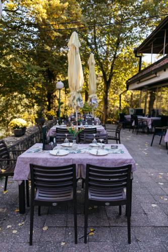 a table with a purple tablecloth and chairs sidx sidx sidx at Hotel Gradche in Kochani