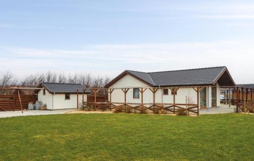a house with black roof and green grass at Holiday Home Hulvej Vinderup Vi in Vinderup
