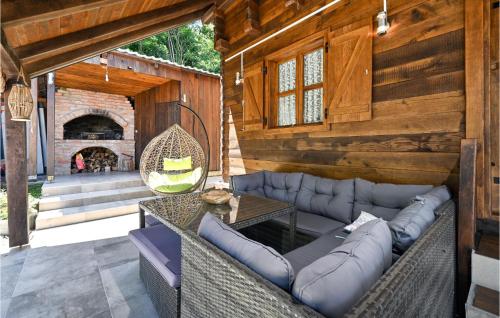 a patio with a couch and a table and a fireplace at Stunning Home In Veliko Trgovisce in Veliko Trgovišće