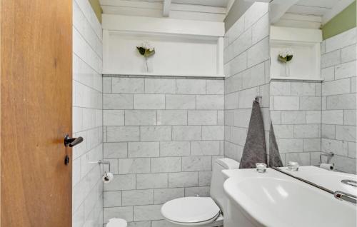 a bathroom with a toilet and a sink at Holiday Home Ringgårdsvej in Hornbæk