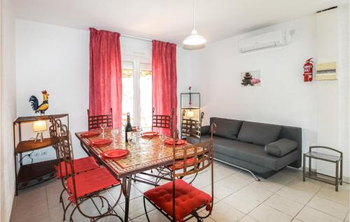a living room with a table and a couch at Amazing Home In Grospierres in Grospierres