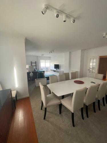 a dining room with a white table and chairs at In Town View in Funchal