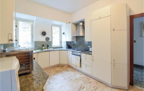 a kitchen with white cabinets and a sink at Cozy Home In Vallerotonda With Wi-Fi in Vallerotonda