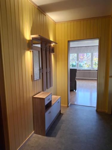 a yellow room with a dresser and a living room at Ferienwohnung Eichweg in Bad Sooden-Allendorf