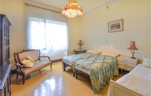 a bedroom with a bed and a chair and a window at Cozy Home In Vallerotonda With Wi-Fi in Vallerotonda