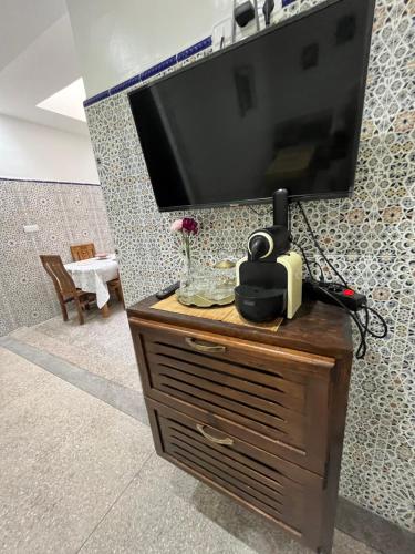 a television on top of a wooden dresser at Agadir House 2 in Agadir