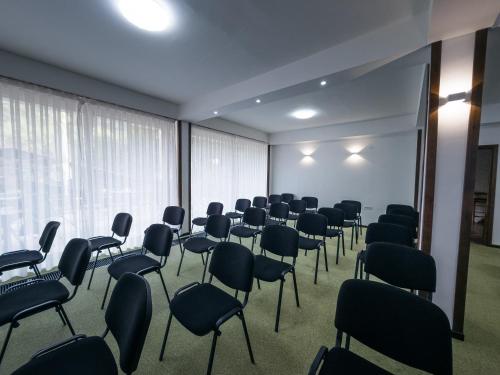 a room filled with chairs and a room with at Hotel Gradche in Kochani