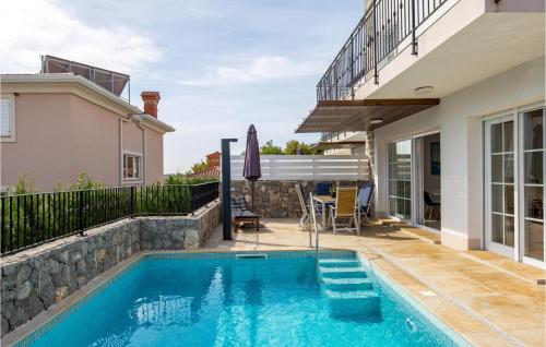 a swimming pool in the backyard of a house at 3 Bedroom Nice Home In Kornic in Kornić