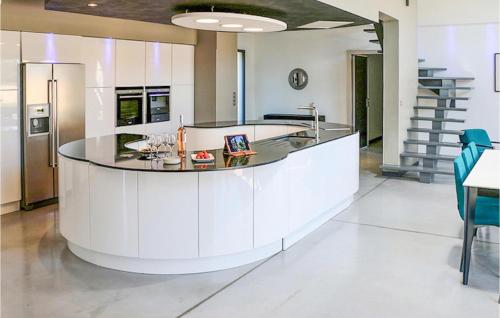 a kitchen with a island in the middle of a room at Cozy Home In Maillane With Kitchen in Maillane