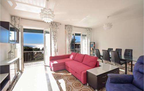 a living room with a pink couch and a balcony at Amazing Apartment In Recco With Kitchen in Recco