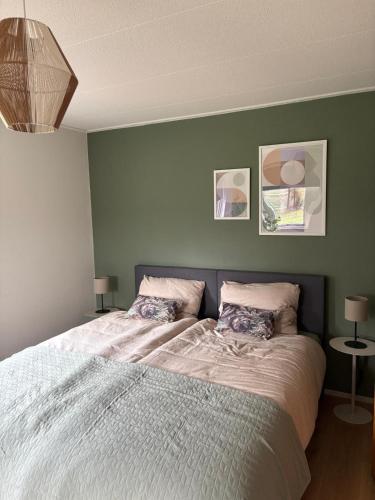 a bedroom with a large bed with two pillows at Bij de Buurman in Dalmsholte