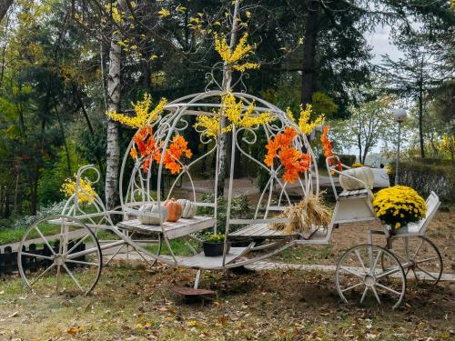 a metal carriage with pumpkins and pumpkins on it at Hotel Gradche in Kochani