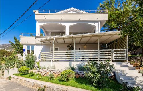 a white house with a balcony on top of it at Gorgeous Home In Cesarica in Cesarica