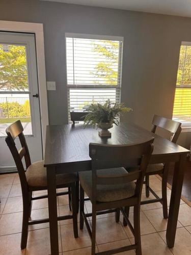 a dining room table and chairs with a plant on it at Lake Front Home, around 15 minutes drive to AT&T and Epic Water in Grand Prairie
