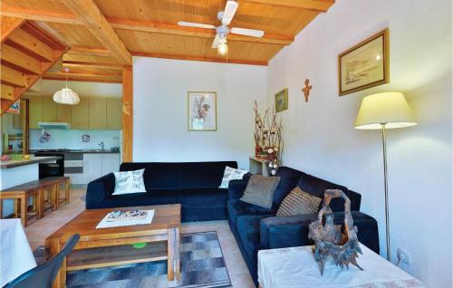 a living room with a blue couch and a table at Gorgeous Home In Trstenik Puscanski in Trstenik Pušćanski