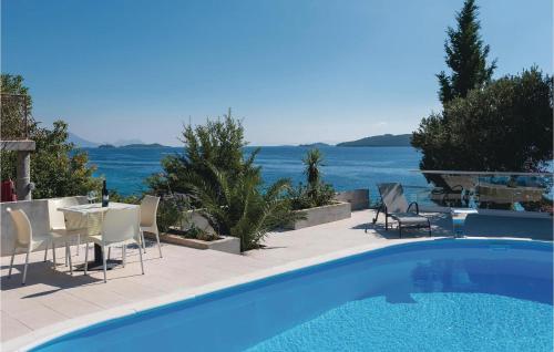 クチフェにあるStunning Home In Kuciste With Saunaの海の景色を望むスイミングプール(椅子、テーブル付)