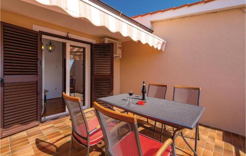 a table and chairs sitting on a patio at Beautiful Apartment In Dinjiska in Dinjiška