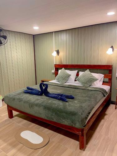 a bedroom with a large bed with blue cords on it at Khao Sok Green Mountain View in Khao Sok