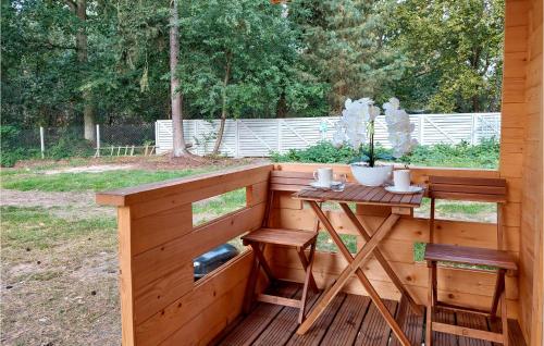 a wooden deck with a table and two chairs at Stunning Home In Pobierowo With Kitchen in Pobierowo