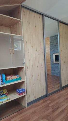 a room with wooden walls and a sliding glass door at Mezonetový apartmán v Osčadnici in Oščadnica