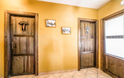 two doors in a room with yellow walls at Stunning Home In Les Coves De Vinromá in Les Coves de Vinroma