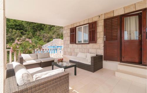 a patio with two couches and a table at Lovely Home In Pucisca With Jacuzzi in Pučišća