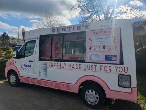 an ice cream truck parked in a parking lot at Barbara's Caravan Craig Tara in Ayr