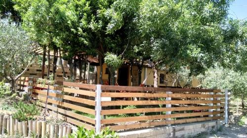 a fence in front of a house with trees at Civettina in Senigallia