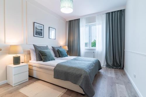 a bedroom with a bed and a window at Riverside - nad rzeką, centrum, Netflix i Max, parking, winda in Iława
