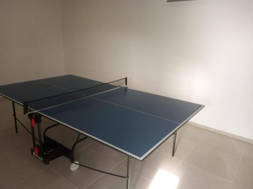 a ping pong table with a tennis racket on it at Three Diamonds Residence in Dunajská Streda