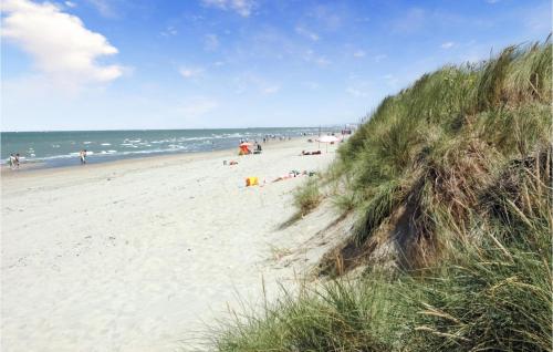a group of people on a beach near the ocean at 3 Bedroom Awesome Home In Oostduinkerke in Oostduinkerke