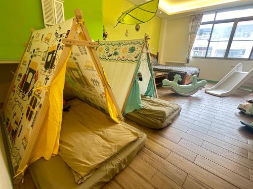 a childs room with a tent and a play area at 台南樂河民宿 in Tainan