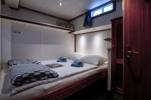 a bedroom with a bed with pillows and a window at MPS Flora in Amsterdam