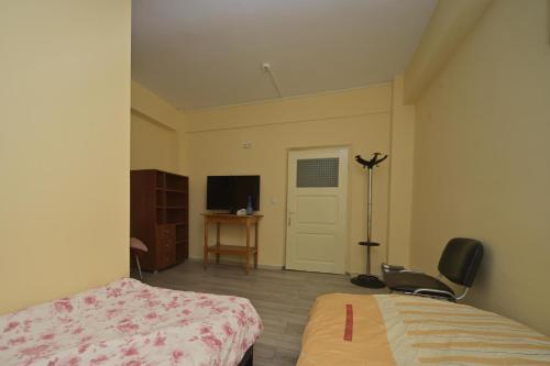 a bedroom with a bed and a desk and a chair at Romblast Srl in Găgeni