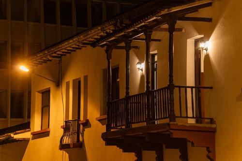 a balcony on a building at night at Hotel Boulevard del Río in Cali