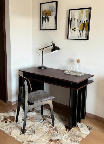 a desk with a chair and a lamp on it at Dream In in Čačak