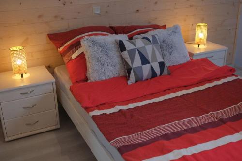 a bedroom with a bed with two night stands and two lamps at Eifeltraum Marianus in Nieder-Emmels