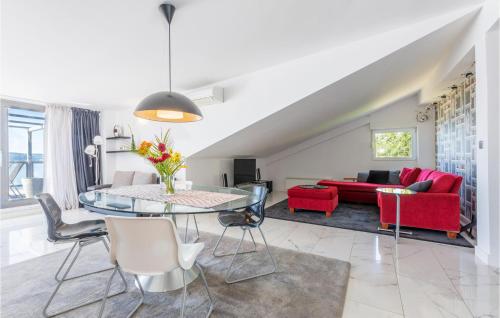 a living room with a table and a red couch at Apartment Krilo Jesenice 24 in Jesenice