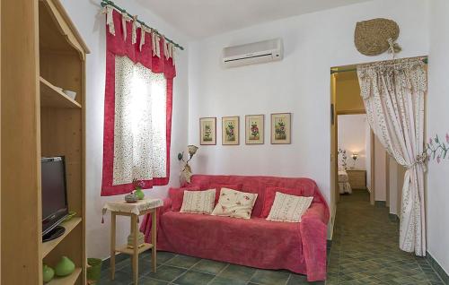 a living room with a red couch and a tv at 6 Bedroom Pet Friendly Home In Siracusa in Siracusa