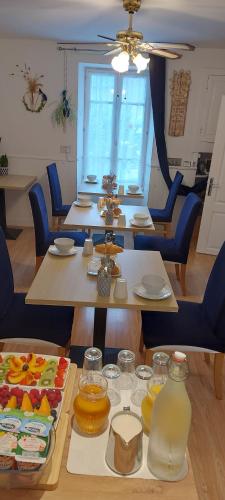 a room with tables and chairs with food on them at Sycamore House in Laurière