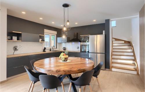 a kitchen and dining room with a wooden table and chairs at Villa Lumalu in Orbanići