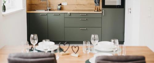 a dining room with a table with glasses on it at Ferienwohnungen Kornkammer und Kirschstübchen in Kettig