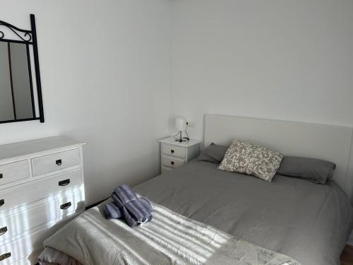 a small bedroom with a bed and a dresser at Apartamento Coqueto in Oviedo