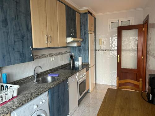 a kitchen with a sink and a dishwasher at Apartamento Coqueto in Oviedo