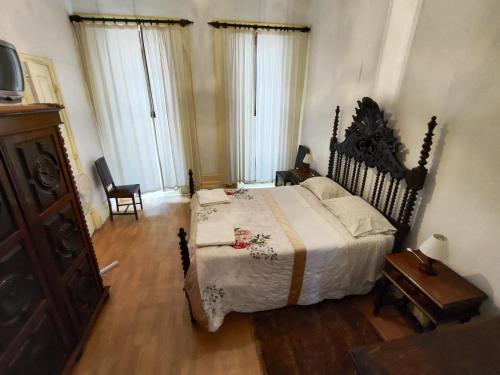 a bedroom with a bed and a dresser and windows at Porto Chique AL 4 in Porto